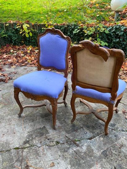 null TWO natural wood chairs moulded and carved with shells, the flat backrest resting...