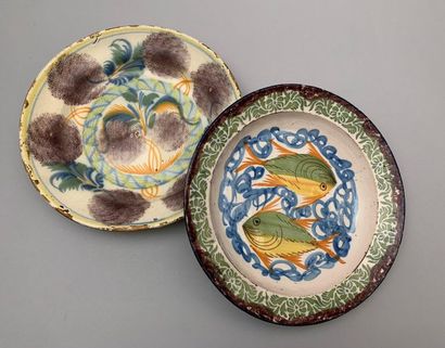null Two deep dishes with polychrome decoration of floral motifs and two fishes....