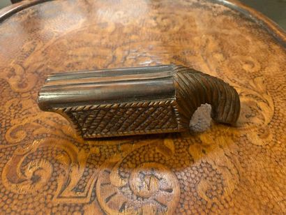 null Snuffbox in the shape of a two-shot pistol with a stylized man's head cushioning...