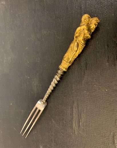 null Three-toothed steel fork with twisted stem and gilt bronze handle, depicting...