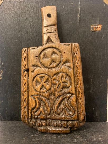 null Butterboard carved with three rosettes and two inflected hearts. Work from the...