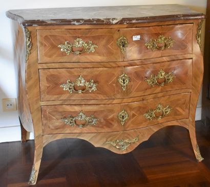 null A curved chest of drawers inlaid with leaves, opening to three drawers, marble...