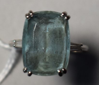 null White gold ring set with a rectangular aquamarine flanked by two baguette-shaped...