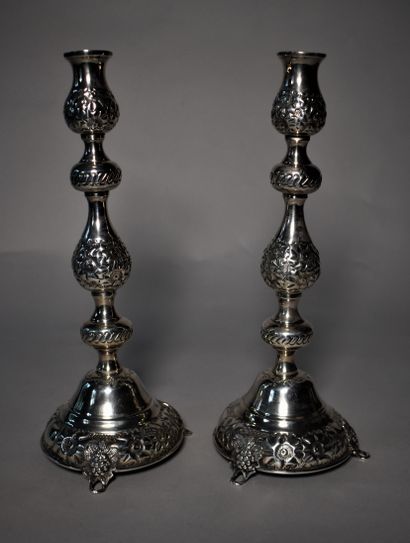 null PAIR OF silver repoussé FLAMBEAUX on three small feet with floral decoration....