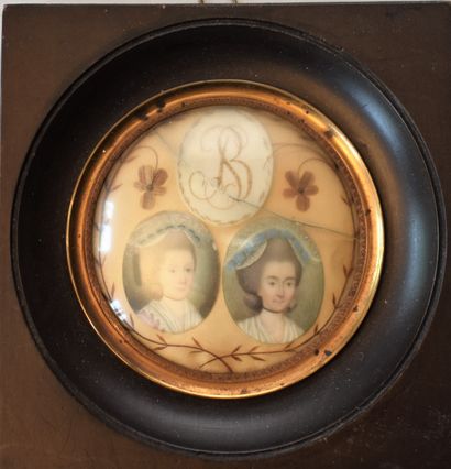 null TWO MINIATURES Portraits of women and a monogram mounted in the same frame of...