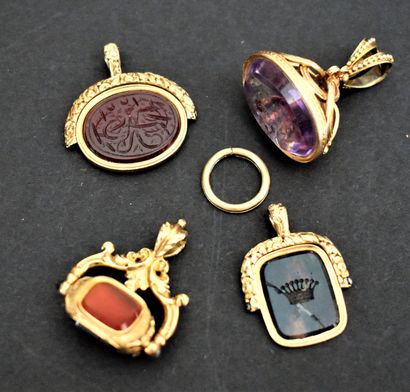 null THREE gold CACHETS charms : one with an agate engraved with arabesques, the...