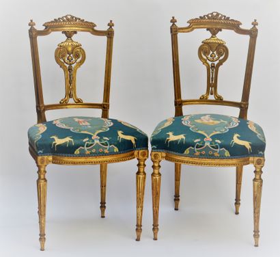 null Pair of light chairs in gilded wood, back with a carved cassolette. Blue silk...