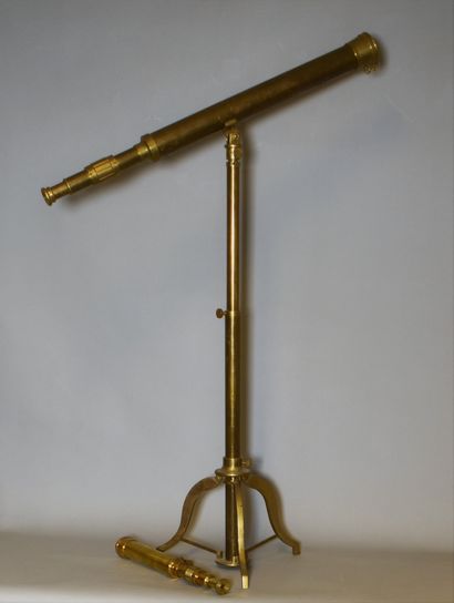 null A gilt bronze and copper library telescope resting on a tripod base. With two...