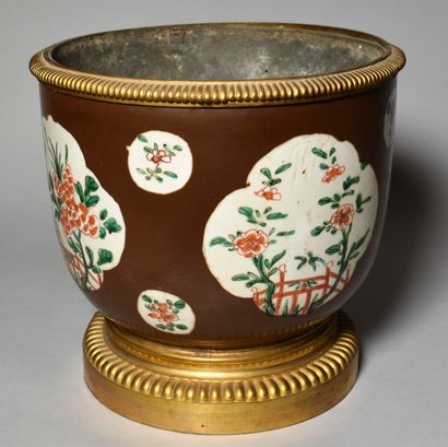 null CHINA: Porcelain CACHE-POT decorated with polychrome flowers on a capuchin background....