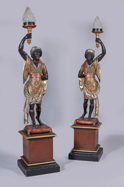 null A pair of giltwood polychrome nubian torchholders, one bearing the label "Alo...