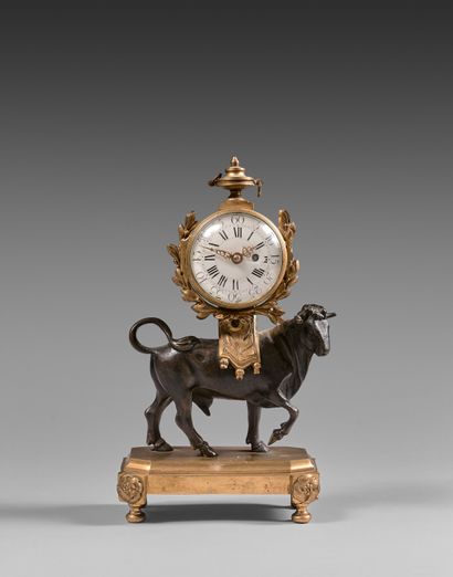 null Chased and gilt bronze "bull" clock. The movement is surmounted by an urn. Rectangular...