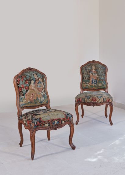 A pair of cabriolet chairs with a curved...