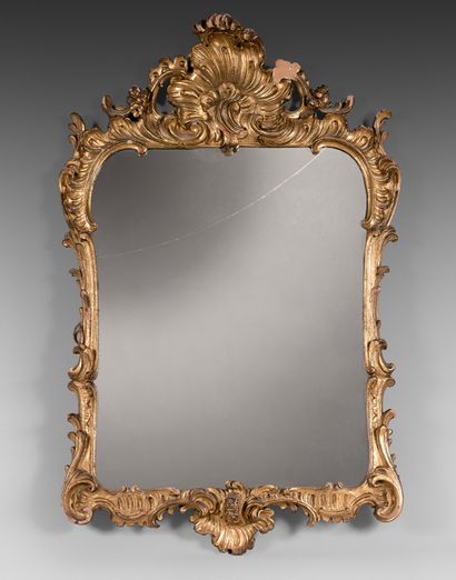 A pair of carved and gilded wooden mirrors...