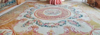 null Important Aubusson carpet with a beige background, decorated with a leafy rose...