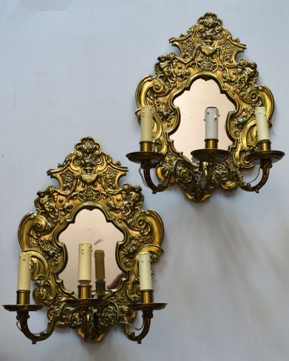 null Pair of bronze three-light GLACES decorated with lovers, vases and foliage....