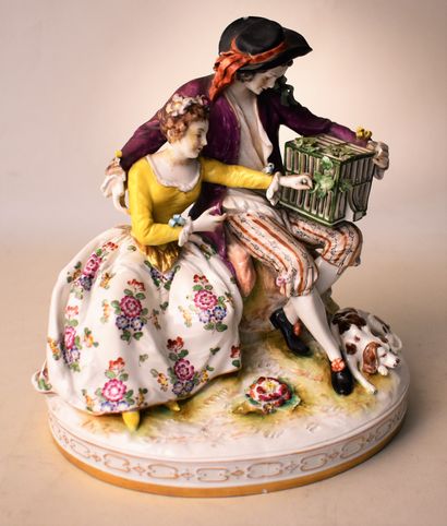null PORCELAIN GROUP representing a couple sitting with a birdcage (accidents). Mark...