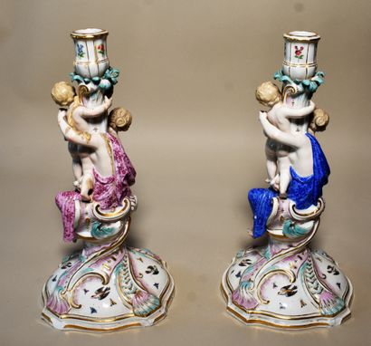 null SAXONY: TWO polychrome porcelain candlesticks decorated with a woman and a child...