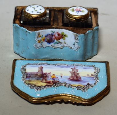 null A blue enamel multi-lobed TRAVELLER with a harbour scene on the cover. With...