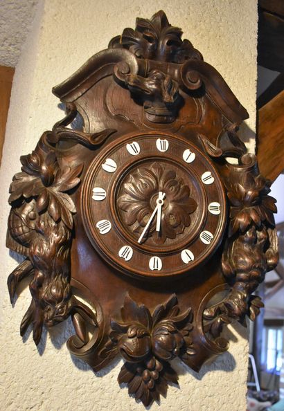 null Wall clock in wood carved with hunting trophies. End of the 19th century. Height...