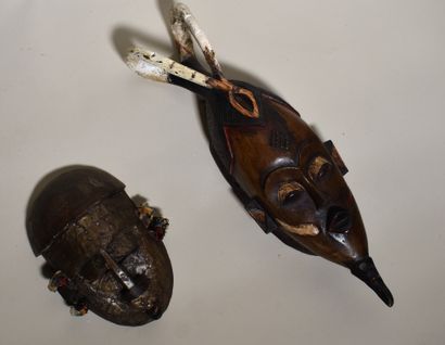 null TWO African MASKS in painted wood or with metallic applications. Height 23 and...