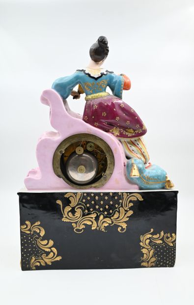 null Gilded and polychromed porcelain CLOCK featuring an oriental woman with a fan....