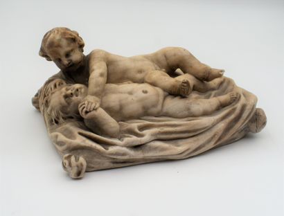A marble paperweight representing two children,...