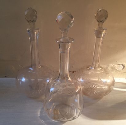 THREE crystal CARAFES, two with plant decoration,...