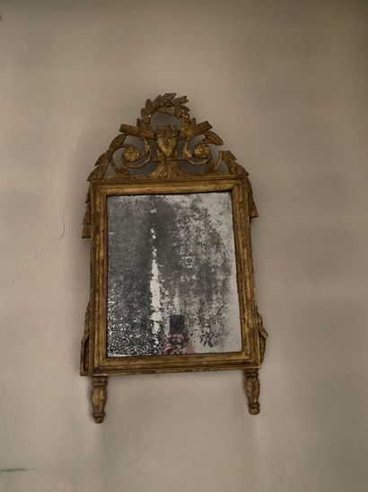 null 
Gilded wood pediment mirror, the upper part decorated with a laurel crown....