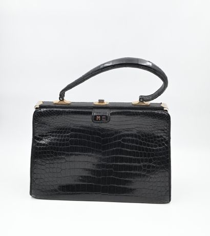 GUENÉ: Handbag in black crocodile. Clasp...