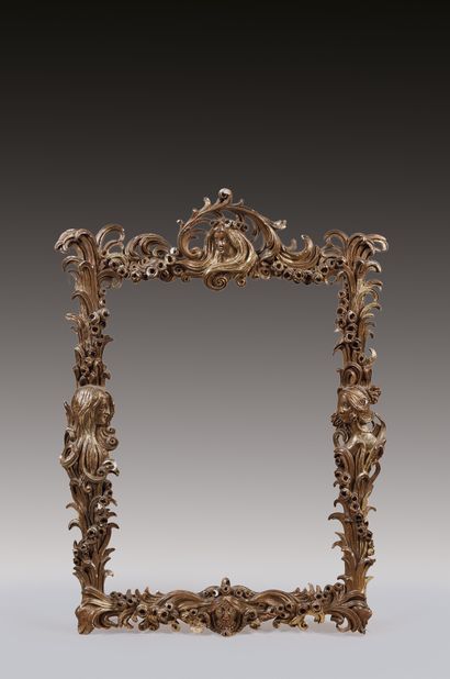 Gilded stucco frame decorated with four heads...