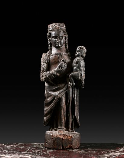 null Virgin and Child in wood holding an apple in her right hand and the Child Jesus...