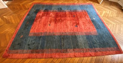 null Rectangular carpet with red background and wide blue border, decorated with...