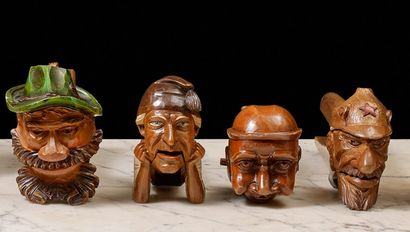 null Four wooden nutcrackers. Two are polychrome, one depicting a Tyrolean head,...
