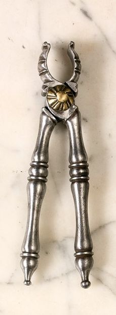 null Wrought-iron nutcracker. Claw model, the joint enhanced by two brass rosettes...