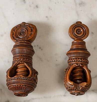 null Four boxwood nutcrackers carved with concentric motifs. Globular cage models....
