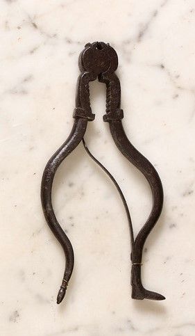 null Wrought-iron pinion breaker. Spring-loaded pliers with curved handles ending...