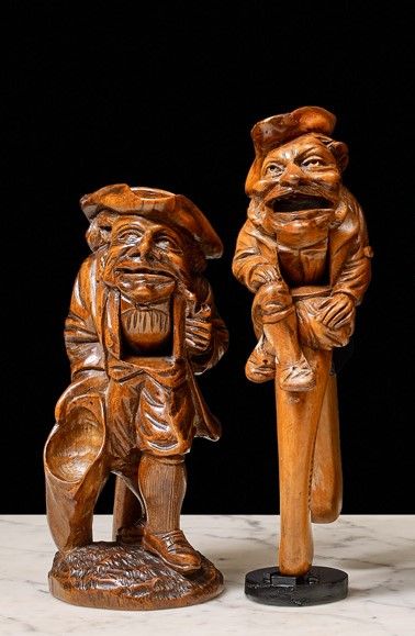 null Two wooden nutcrackers, pincer models. One features a full-length pipe smoker...