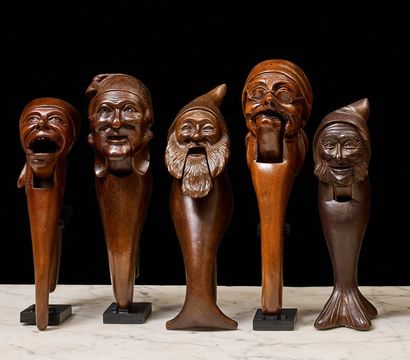 null Five wooden nutcrackers in various woods. Pincer models featuring a man's head...