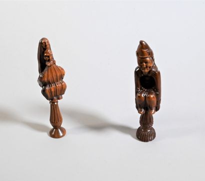null Two conifer nutcrackers. Cage models. One depicts a nun leaning against an old...
