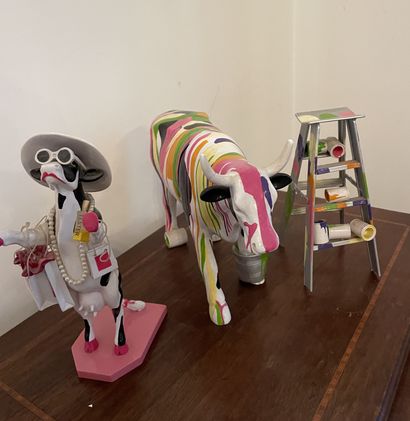 null LOT of two polychrome resin cow figurines and a stepladder with paint pots.