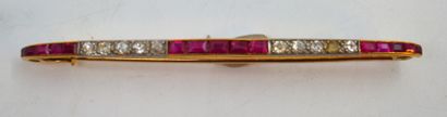 null Barrette brooch in yellow gold, set with red stones alternating with small diamonds....