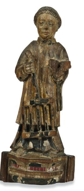 null Statuette de saint Laurent en chêne sculpté avec traces de polychromie. Il tient...