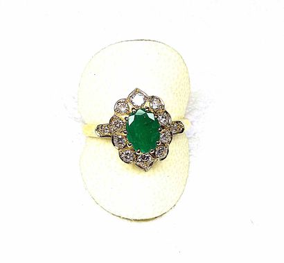 null Ring 

Yellow gold set with an oval green Colombian emerald in a setting of...