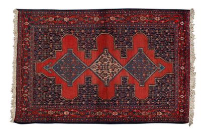 null SENNEH with a midnight blue field with Herati motifs decorated with three geometric...
