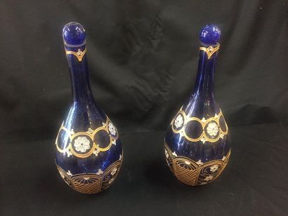null Pair of blue glass carafes with swollen belly with enamelled and gilded decoration...