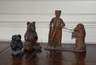 null GROUP in carved wood depicting a bear watchman and his beast. Eastern Europe,...