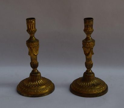 null PAIR OF CANDLES in gilded bronze decorated with piastres and garlands of laurel....