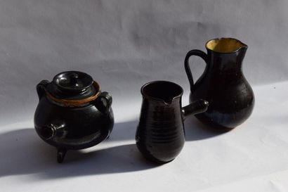 null Set comprising a covered goat's head, a pitcher and a black glazed earthenware...