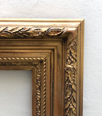 null Wood and stucco frame, carved and gilded, decorated with foliage and ribbons....