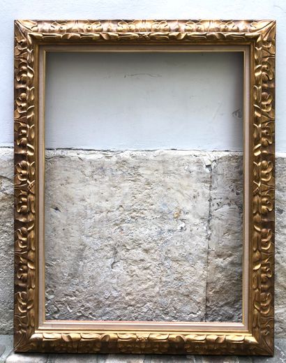 null A wood and stucco frame with an upside-down profile and large acanthus leaves....